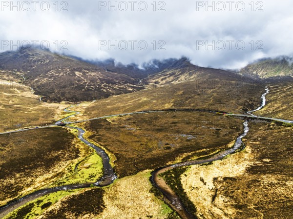 Eas a' Bhradain Waterfall from drone, Red Cuillin mountains, Loch Ainort, Isle of Skye, Scotland,