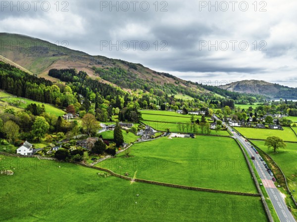 Farms and Mountains over road A591 from a drone, Grasmere Lake, Grasmere, Ambleside, Lake District,