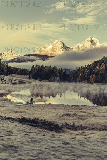 Lake Staz near Sankt Moritz in the Engadin in Switzerland. Morning atmosphere with fog in autumn.