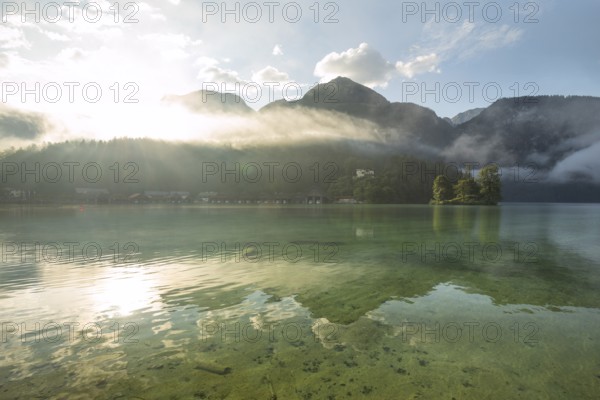 Mystical morning at Königssee in Schönau with boathouses and Christlieger. Sunrise and beautiful