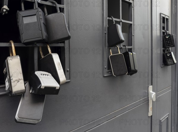 Key boxes on a grille of a basement window for flat flats in the city centre of Bratislava,