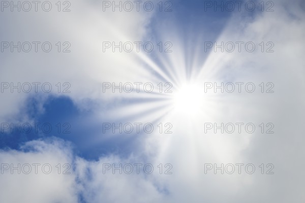 Symbolic image, global warming, heat, bright sunshine penetrates thin clouds and illuminates the