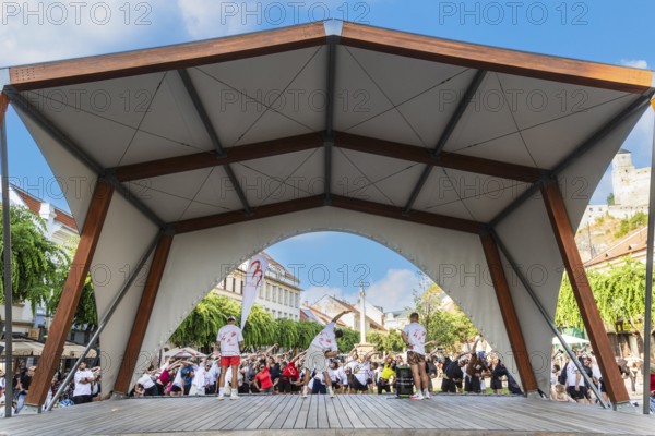 An event by a local fitness centre takes place on a stage on Peace Square, Capital of Culture 2026,