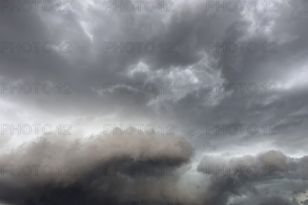Below dark discoloured storm clouds Cloud roll above grey clouds Rain clouds heralding