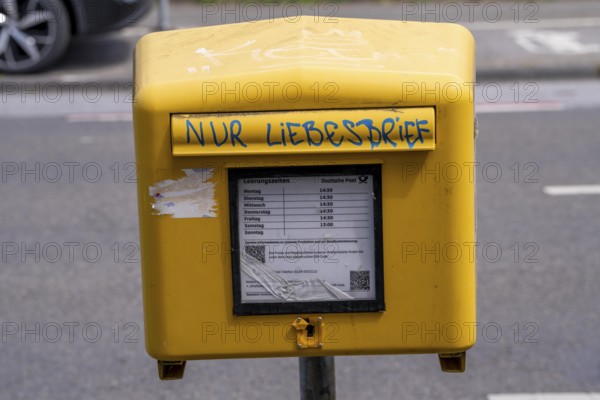 Deutsche Post letterbox, with stickers and graffiti, labelled Only love letters, Leverkusen, North