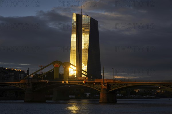 The light of the setting sun is reflected on the glass façade of the European Central Bank (ECB) in