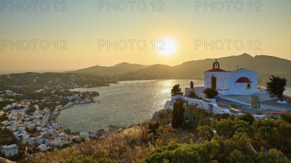 Profitis Ilias Church, Small church on a hill overlooking the calm sea at sunset, surrounded by a