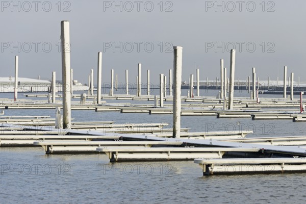 Winter day, onset of winter, snow on the jetties in the marina, North Sea, Norddeich, Lower Saxony,