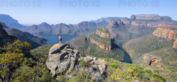Hiker enjoying panorama, Blyde River Canyon with summit Three Rondawels, view of canyon with river