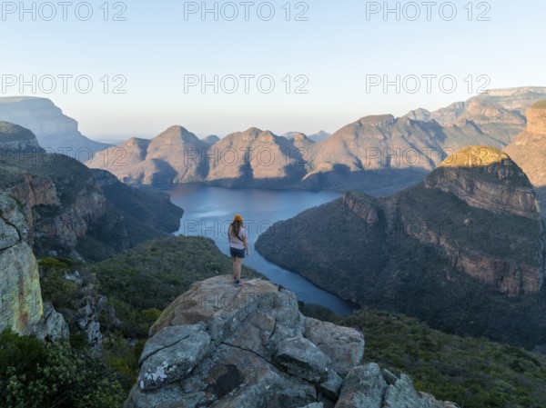 Hiker enjoying panorama, Blyde River Canyon with summit Three Rondawels, view of canyon with river