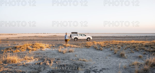 Tourist with off-road car exploring dry landscape, Kubu Island (Lekubu), Sowa Pan, Makgadikgadi