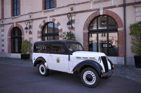 Black and white Renault Juvaquatre Editorial vintage car in front of headquarters, head office,