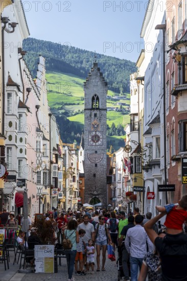 Old town, colourful houses in the main street, Zwölferturm tower at the back, old town, Sterzing,