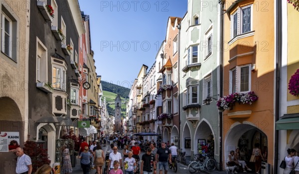 Old town, colourful houses in the main street, Zwölferturm tower at the back, old town, Sterzing,