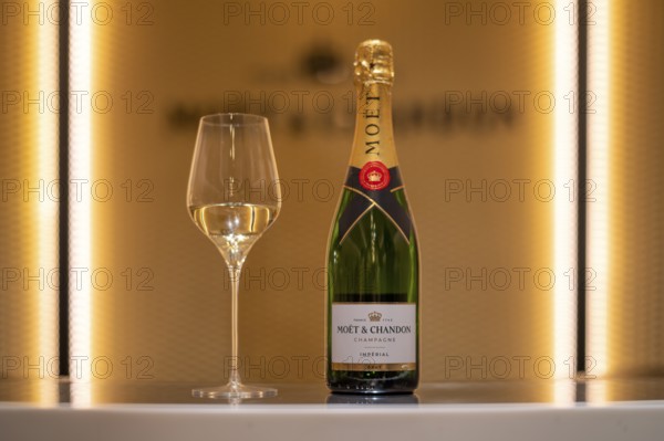 Bottle of Champagne Impérial Brut, filled glass, logo, lettering, headquarters of the champagne