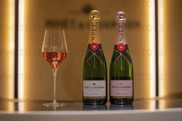Bottle of Champagne Rosé and Impérial Brut, filled glass, logo, lettering, headquarters of the