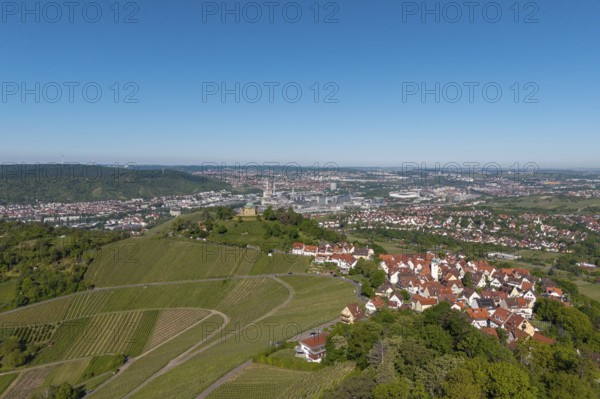 Urban landscape with vineyards, red roofs and fields under a blue sky, view of Rotenberg near