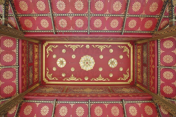 Ceiling with floral red and golden decorations in the Siamese Sala-Thai I temple, detail, pattern,