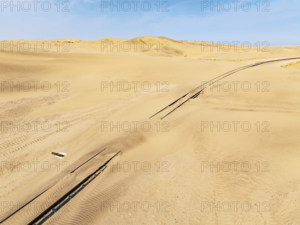 Rails covered with sand in the southern Namib Desert. Aerial view. Drone shot. Namibia