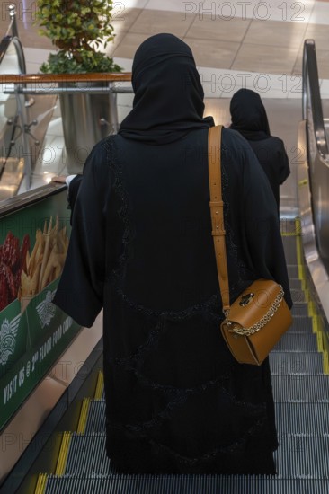 Veiled woman with handbag, Abu Dhabi, United Arab Emirates
