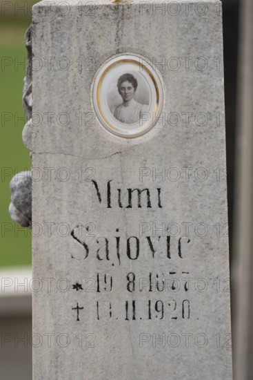 Old gravestone with inscription and an oval photo portrait, Zgornje Jezersko, Gorenjska, Slovenia