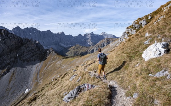 Mountaineers on a hiking trail at the Gamsjoch, picturesque mountain landscape in autumn, view of
