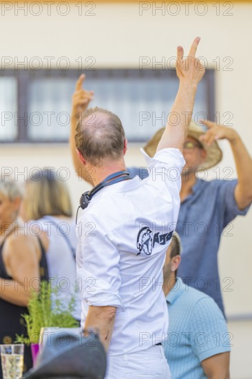 People standing in a relaxed atmosphere at an outdoor summer party, 950th anniversary of Weil der