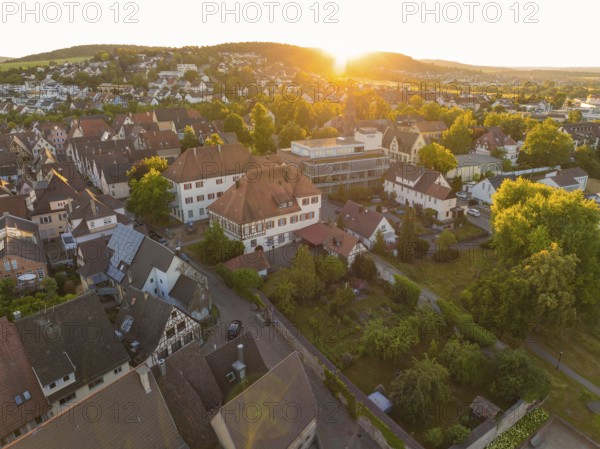 Peaceful sunset over a village with houses and lush vegetation in the landscape, 950 years Weil der