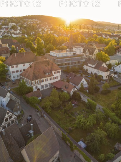 Idyllic view of a village at sunset with historic buildings and lush greenery, 950 years Weil der