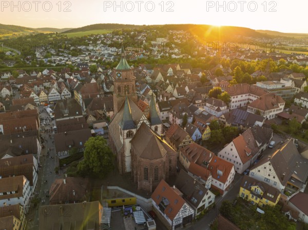 A bird's eye view of the evening cityscape with church at sunset, 950 years Weil der Stadt