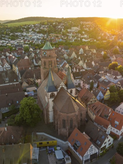 Aerial view of a church and old town centre in the evening light with surrounding landscape, 950