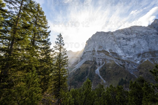 Mountain landscape in autumn, sun star in the morning light, rocky mountain peak of the