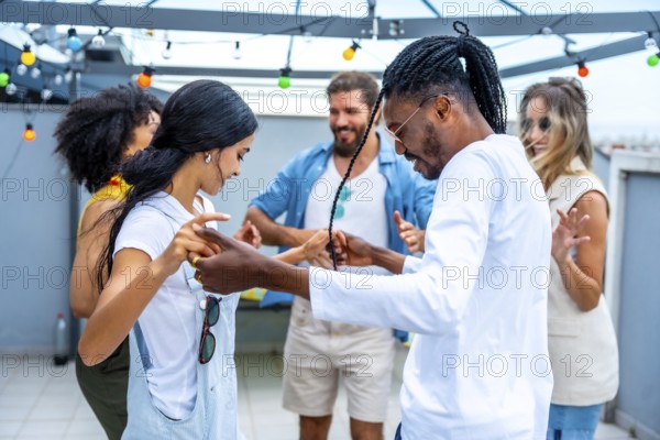 Young people dancing joyfully at a vibrant rooftop party, soaking in the summertime atmosphere and