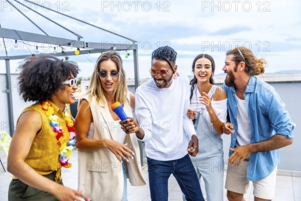 Diverse group of friends enjoying a lively karaoke session, singing, dancing, and celebrating