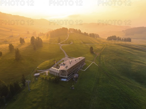 Architectural building on a hill with evening light and peaceful atmosphere, Alpe di Siusi,