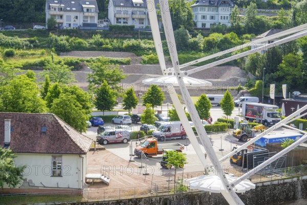 View of the town and parked vehicles from a Ferris wheel, Ferris wheel construction, Calw, Black