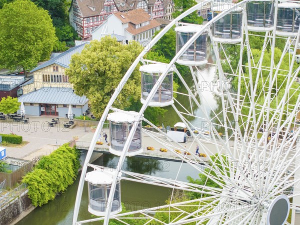Ferris wheel overlooking a river and surrounding village landscape in the countryside, Ferris wheel