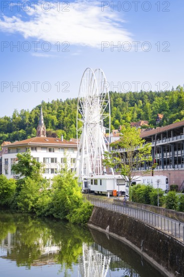 Ferris wheel in an urban environment with church and river in the background, Ferris wheel