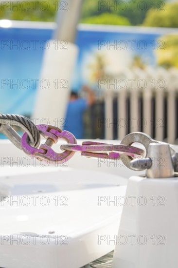 Close-up of a metal connection in front of a blurred background in pastel colours, Ferris wheel