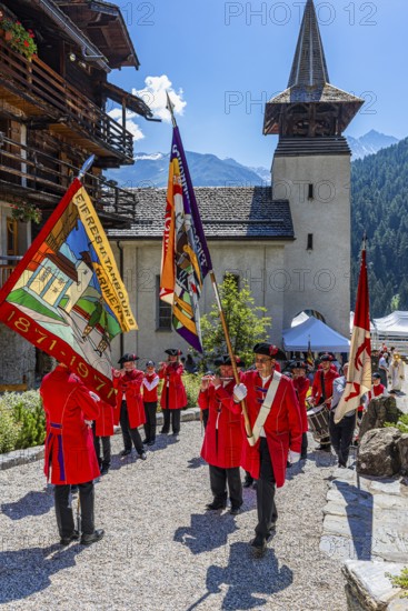 Pipers and drummers line up for the Corpus Christi procession, behind the church of Saint Theodul,