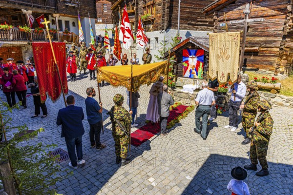 The priest celebrates a service at the flower-decorated altar during the Corpus Christi procession,