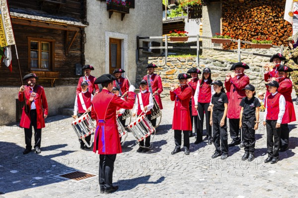 Pipers and drummers play in the historic village centre, Grimentz, Val d'Anniviers, Valais Alps,