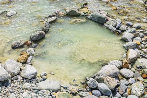 Boulders form a circle in the mountain stream La Navisence, near Zinal, Val d'Anniviers, Valais