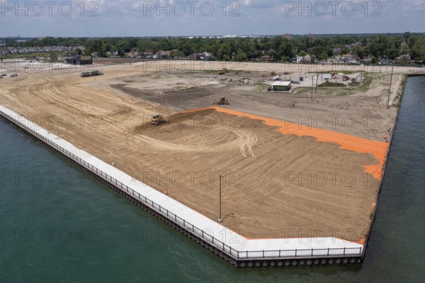 Detroit, Michigan - Workers spread clean dirt after old industrial contamination of cadmium,