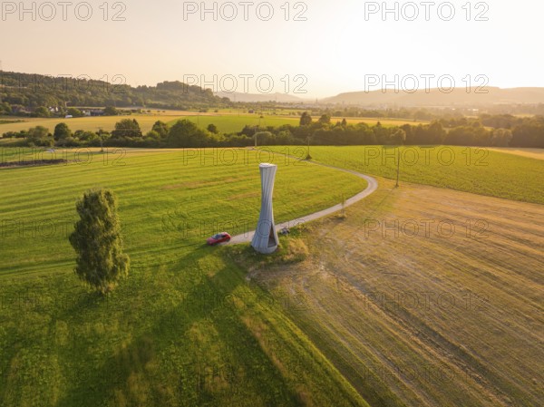 Panorama of a green landscape with a modern observation tower in the sun