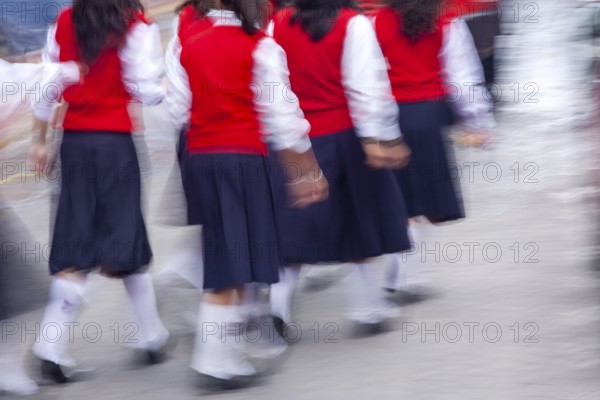 Group of female students walking to the college, Motion blur, City of Otavalo, Imbabura province,