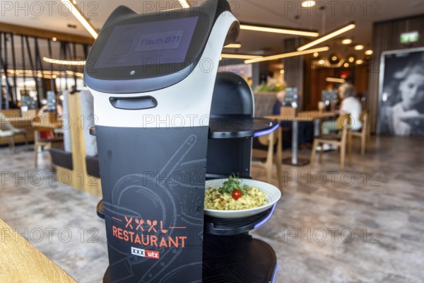 Furniture store XXXLutz Mann Mobilia Karlsruhe. In the restaurant, serving robot Lutzi supports the