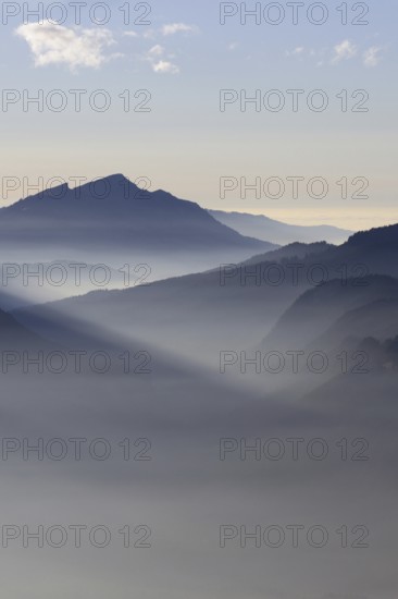 Mountain silhouettes... Alpine peaks and mountain ranges in the Bavarian Alps, light fog rises from