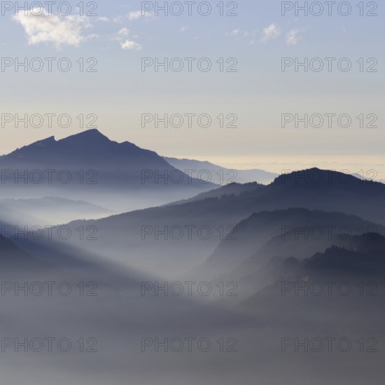 Mountain silhouettes... Alpine peaks and mountain ranges in the Bavarian Alps, light fog rises from