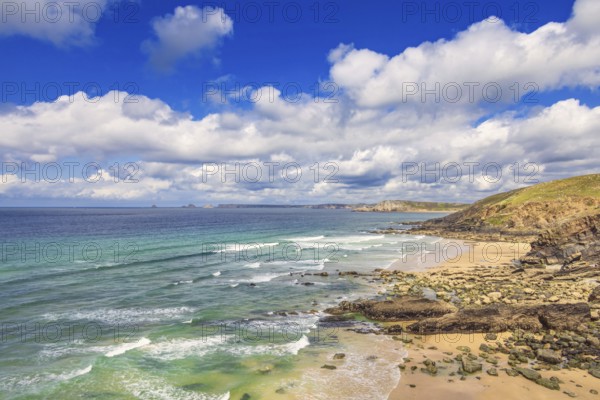 Rocky coastline with breaking waves on the shore and a scenics view to the horizon a sunny summer